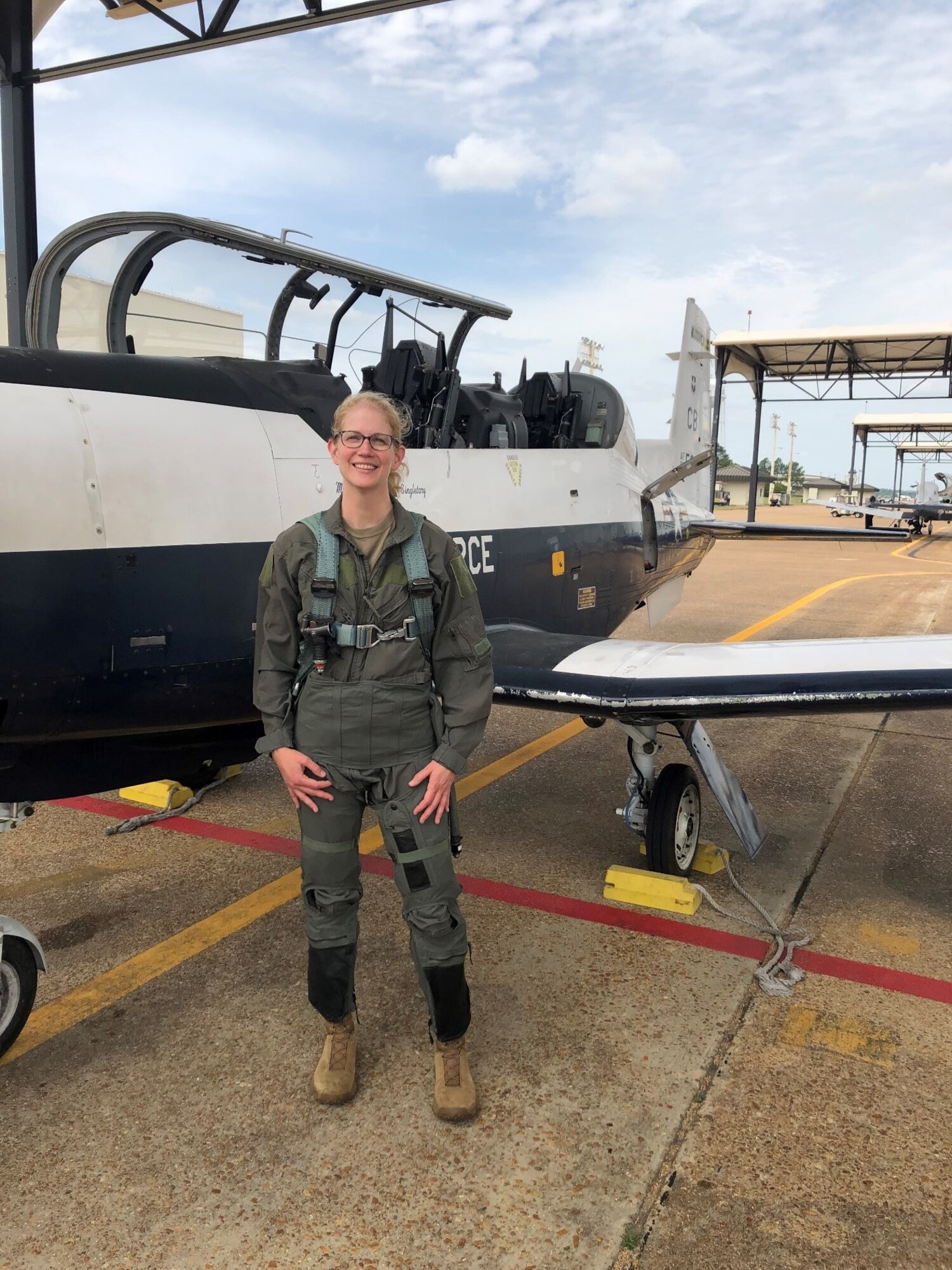 PHOTO OF Maj. Nancy DeLaney, aviation psychologist, posing in front of a T-6 Texan.