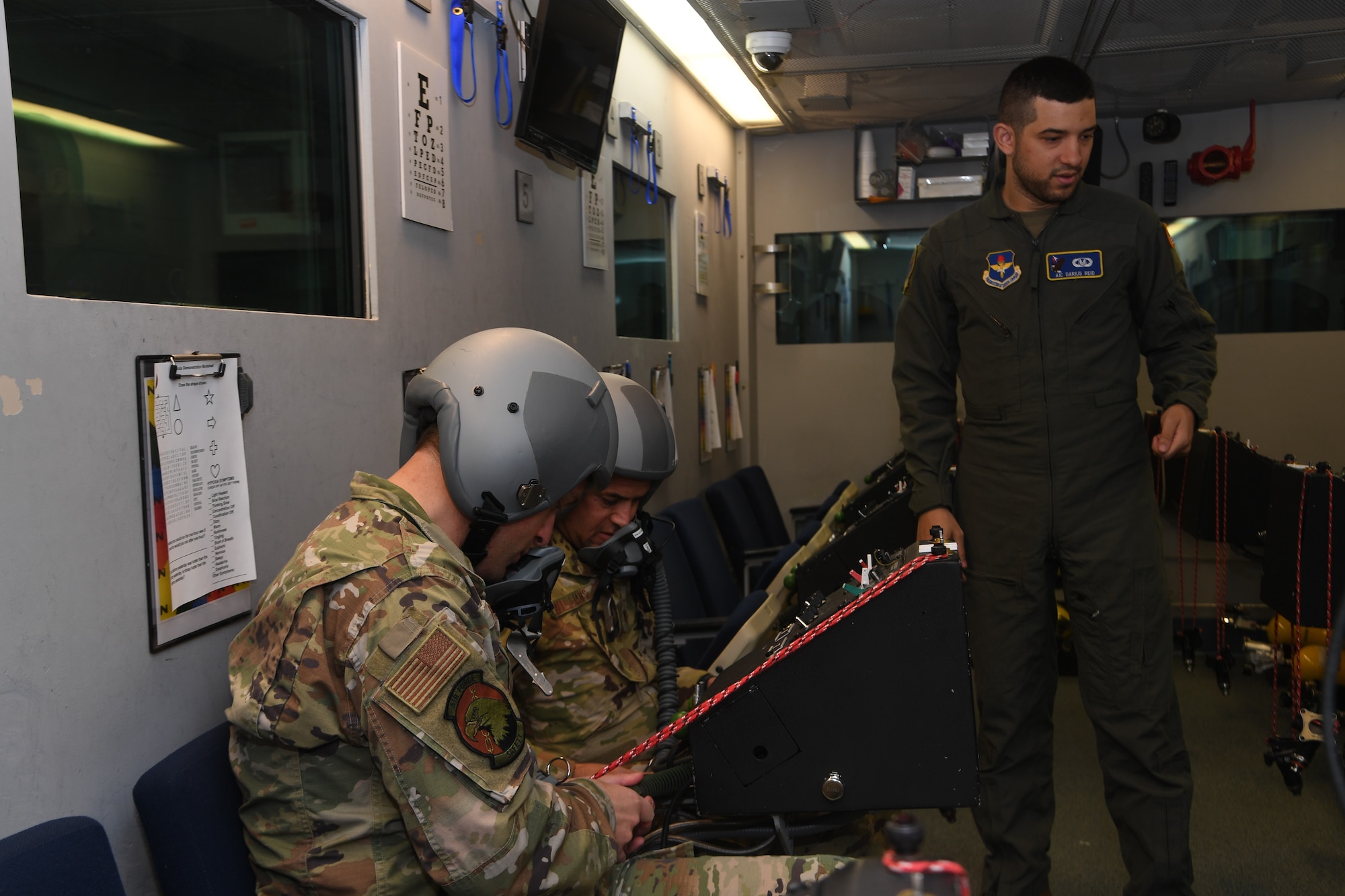 Maj. Bryan Presler and Maj. Owen John Williams, prepare to experience the altitude chamber