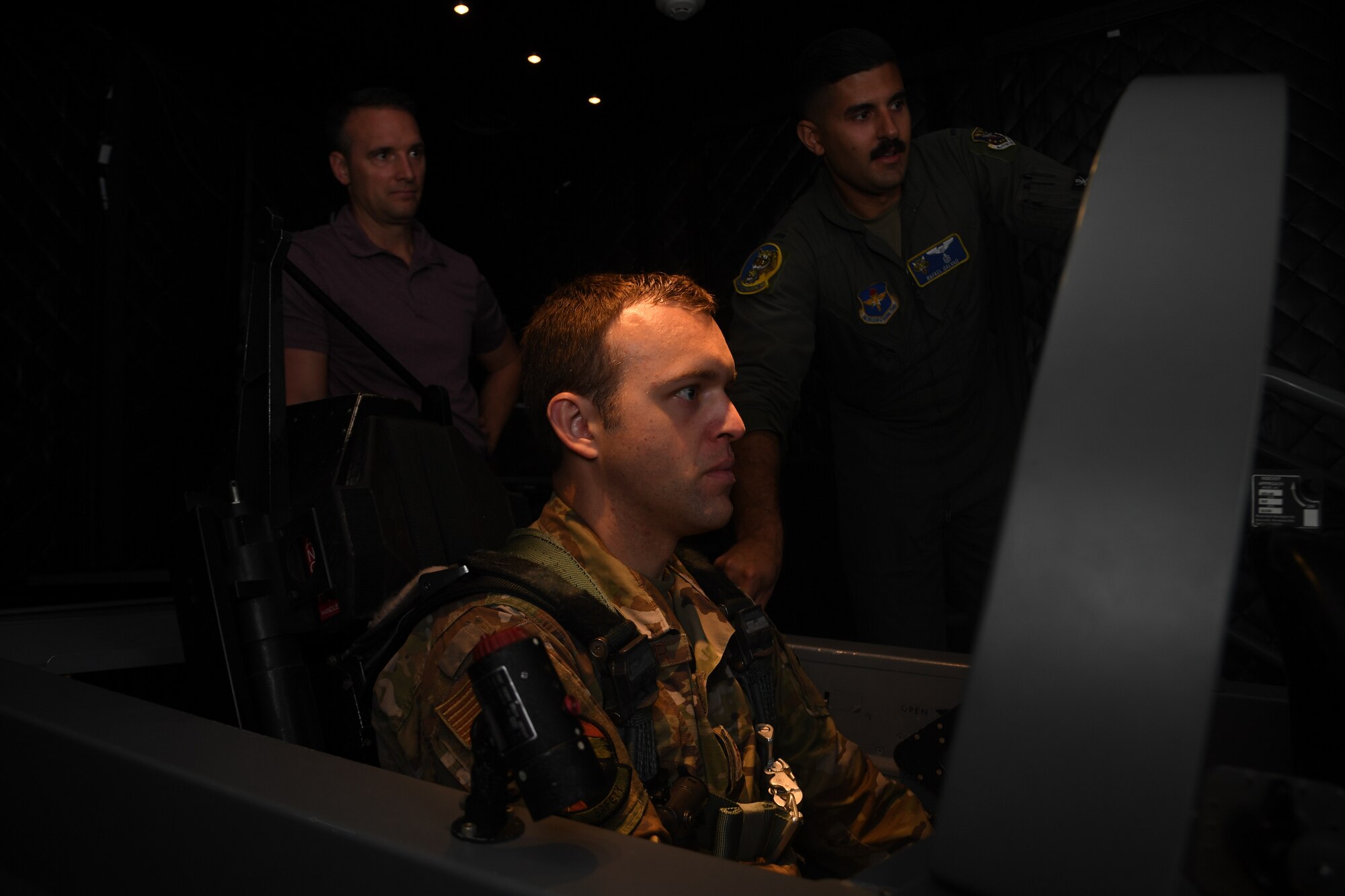 Maj. Bryan Presler learns how to fly a T-6 Texan in the simulator under the instruction of 1Lt. Rafael Galvao
