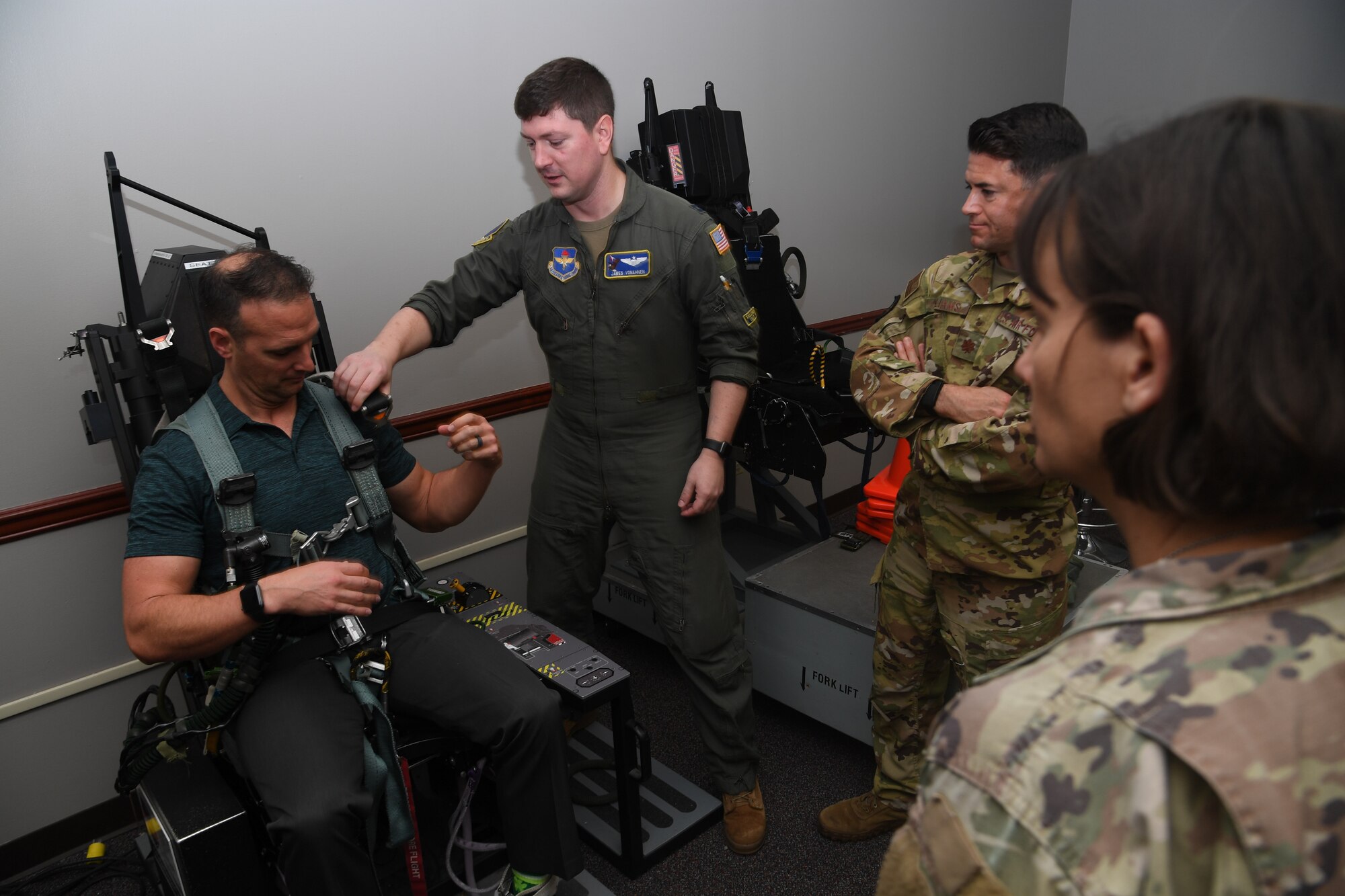 Dr. John Gassaway receives instruction on how to secure himself and egress from an ejection seat