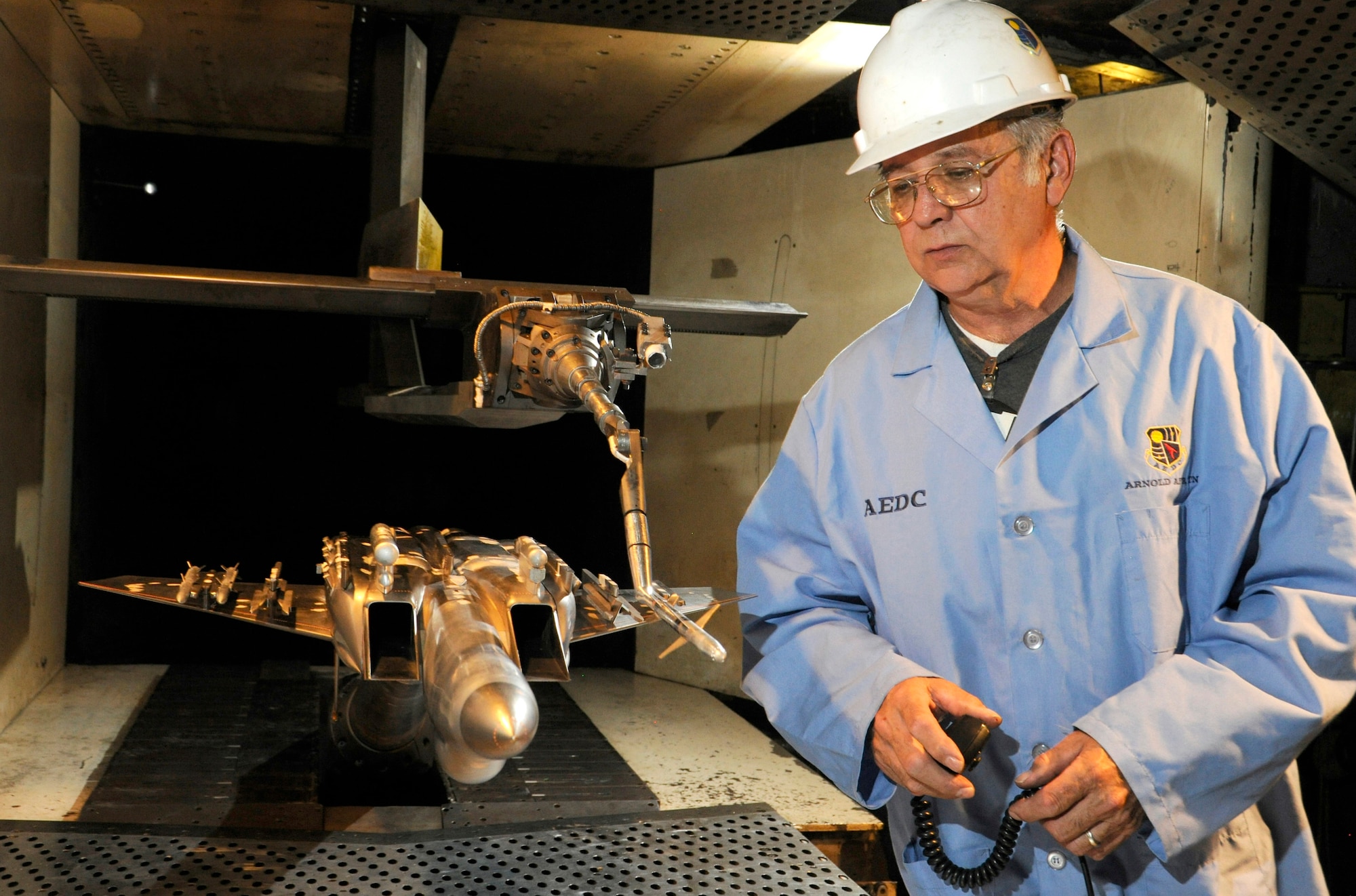 Machinist Dennis Odear inspects a 5% model of the F-15SA Eagle before it undergoes testing in 2012 in the 4-foot transonic wind tunnel at Arnold Air Force Base, Tennessee, headquarters of Arnold Engineering Development Complex. The Air Force recently celebrated the 50th anniversary of the F-15’s deployment. Models of the aircraft, engines and other F-15 components have frequently been tested in AEDC facilities over the past 50 years. (U.S. Air Force photo by Rick Goodfriend)