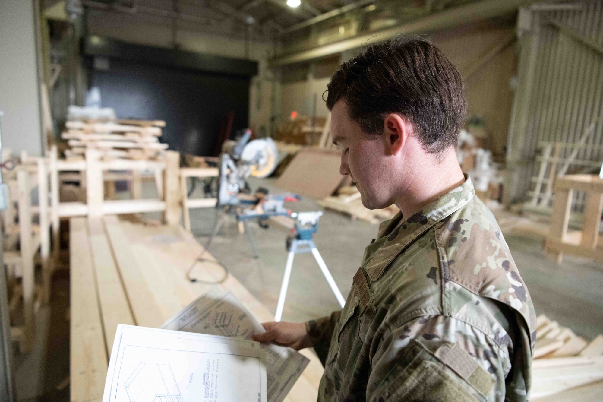 A military member looks over the blocks and brace instructions.
