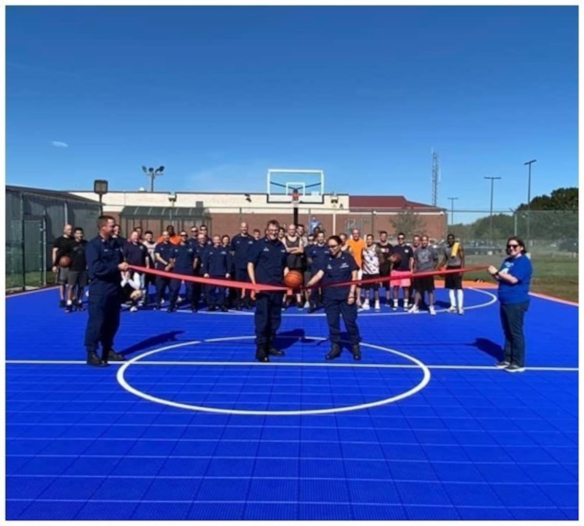 Coast Guard members attend a ribbon-cutting ceremony for a renovated basketball court at Sector Long Island Sound, Connecticut, Oct. 20, 2021 (U.S. Coast Guard photo by Lt. j.g. Sarah Dupre).