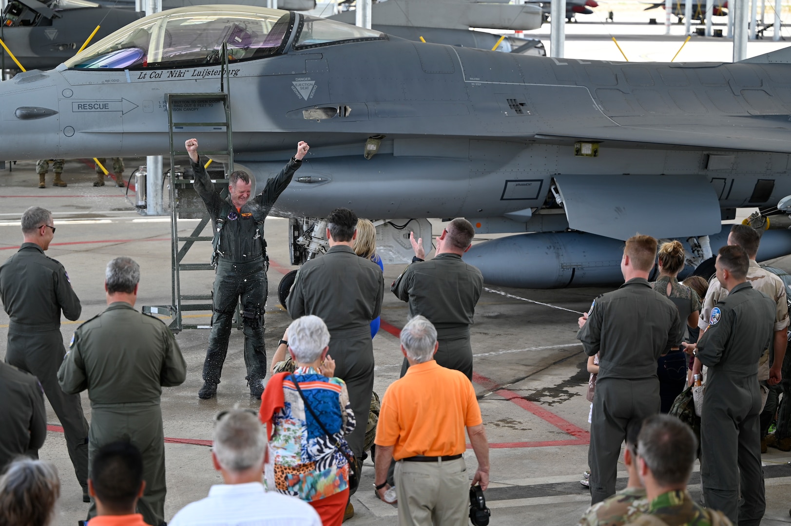 Lt. Col. Joost Luijsterburg, the Royal Netherlands Air Force detachment commander, is sprayed with water after completing his final flight in an F-16 at the Morris Air National Guard Base in Tucson, Ariz., July 29, 2022. Luijsterburg has already assumed command of the Dutch F-35 detachment at Luke Air Force Base, Arizona, and has been acting as dual commander of both detachments.