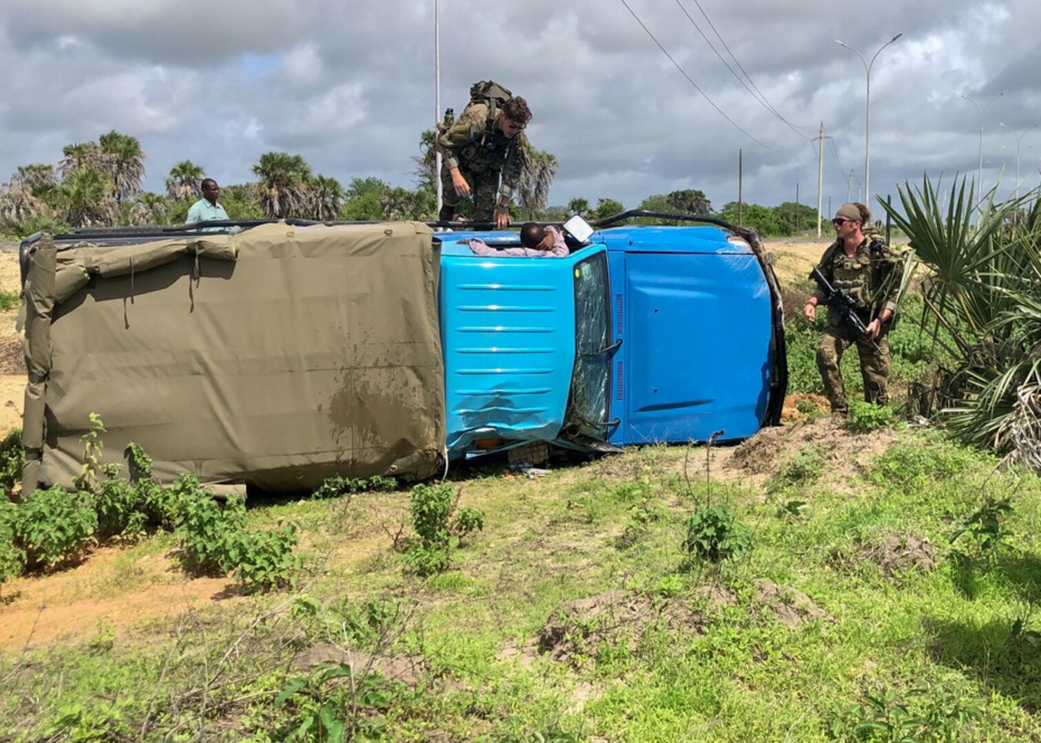 Virginia National Guard Soldiers assigned to 1st Squad, 1st Platoon, B Company, 1-116th Infantry Regiment, Task Force Red Dragon, Combined Joint Task Force - Horn of Africa respond to a vehicle accident during an area security patrol May 25, 2022, in Manda Bay, Kenya.