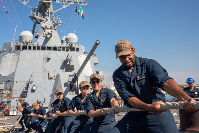 Sailors heave a mooring line on the fo’c’sle aboard the Arleigh Burke-class guided-missile destroyer USS Bainbridge (DDG 96) during a scheduled port visit to Civitavecchia, Italy Aug. 2, 2022. Bainbridge is on a scheduled deployment in the U.S. Naval Forces Europe area of operations, employed by U.S. Sixth Fleet to defend U.S., allied and partner interests.