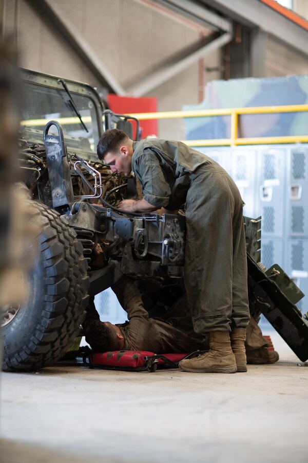 U.S. Marine Corps Lance Cpl. Allen Hantz, bottom, an automotive maintenance technician assigned to Truck Company, 23rd Marine Regiment, from Lake Charles, La., and Pfc. Elias Mandur, right, an automotive maintenance technician assigned to 3rd Battalion, 11th Marine Regiment, conduct maintenance on a Humvee during Integrated Training Exercise 4-22, at Marine Corps Air-Ground Combat Center, Twentynine Palms, Calif., July 26, 2022. Marine Air Ground Task Force 23 aggregated at Marine Corps Air-Ground Combat Center from 55 Home Training Centers, further preparing Marine Forces Reserve for potential future mobilizations and deployments. (U.S. Marine Corps photo by Cpl. James Stanfield)