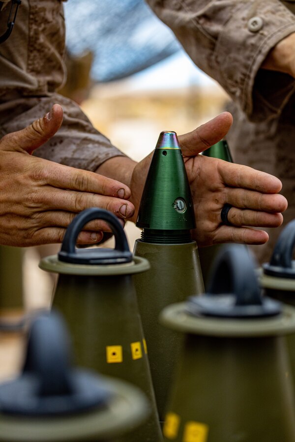 U.S. Marine Corps Lance Cpl. Clayton Cole, a field artillery cannoneer with Sierra Battery, 2nd Battalion, 10th Marines, prepares a M1122 High Explosive round during Integrated Training Explosive 4-22 at Marine Corps Air Ground Combat Center, Twentynine Palms, Calif., July 27, 2022. Marines from 10th Marines are augmenting 3rd Battalion, 14th Marine Regiment, as the Active and Reserve Components continue to integrate to increase proficiency of Total Force operations. (U.S. Marine Corps photo by Cpl. Ryan Schmid)