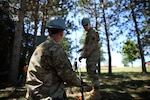 Airman 1st Class James Iwen, a cyber transport specialist with the 128th Air Control Squadron, assists with assembling an antenna during the squadron's annual training at Volk Field, Wis., July 18, 2022.