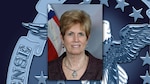 A portrait of Janet Hoffheins over a DLA emblem background