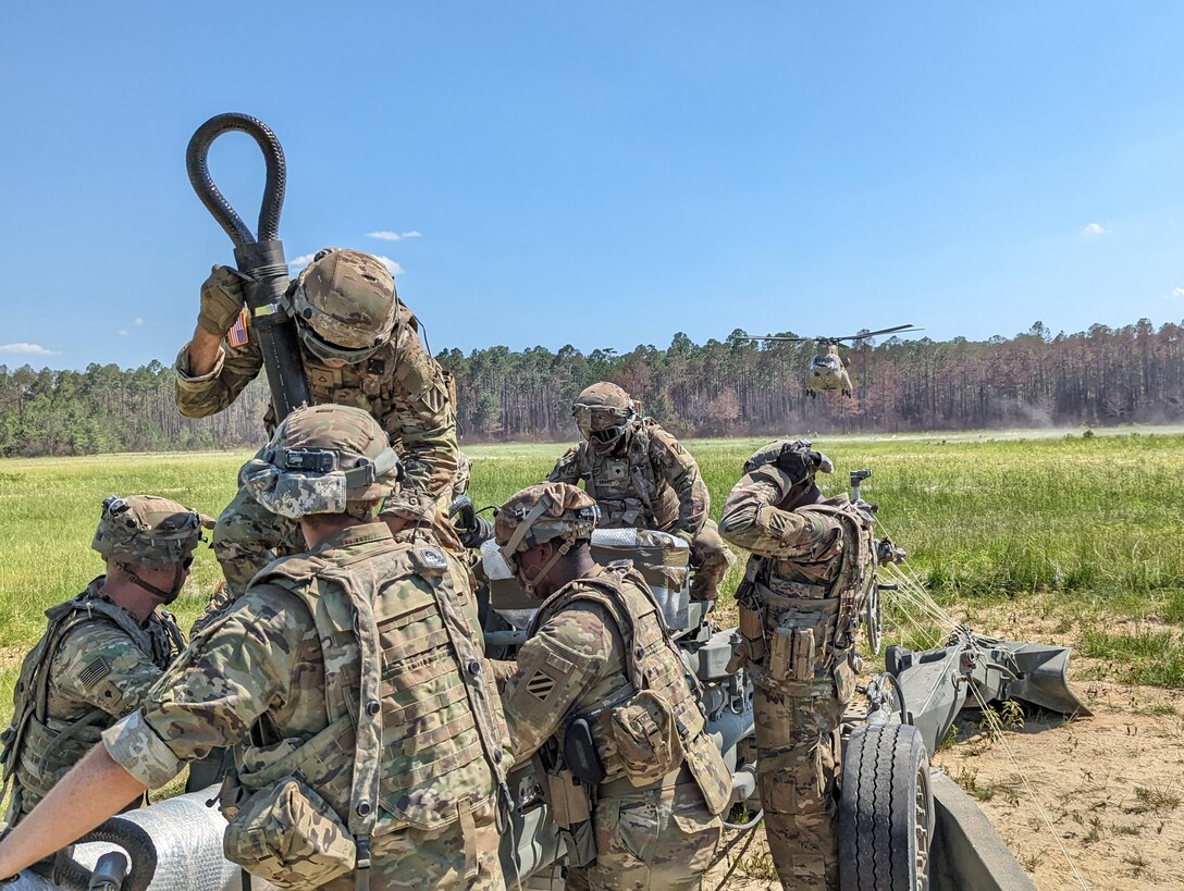 Georgia Army National Guard Soldiers from C Battery, 1st Battalion, 118th Field Artillery Regiment, prepare an M777 Howitzer to be airlifted by a CH-47 Chinook during air assault raid training, June 22, 2022 on Fort Stewart, Ga.