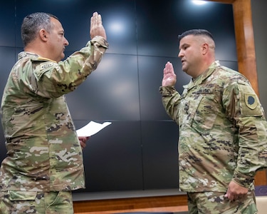 Brig. Gen. Mark Alessia, of Sherman, Illinois, Director of the Joint Staff, Illinois National Guard, administers the oath of office to newly promoted Illinois Army National Guard Col. Shawn Nokes, of Springfield, Illinois, during a promotion ceremony Aug. 1 at the Illinois Military Academy, Camp Lincoln, in Springfield, Illinois.