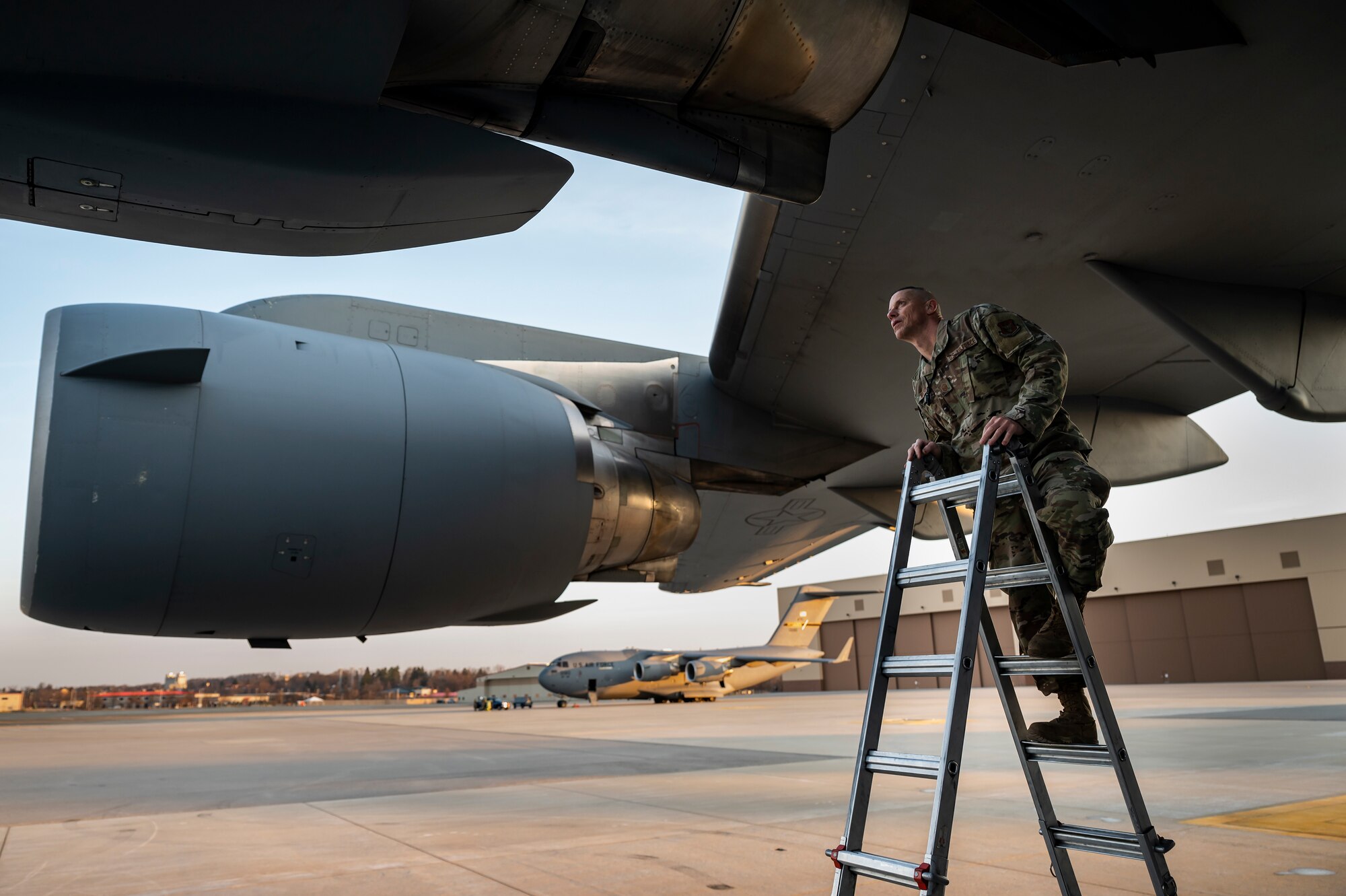 Master Sgt. Eugene Wilson, 911th Maintenance Squadron aerospace propulsion technician, inspects an engine on a C-17 Globemaster III while preparing for an eco-wash at the Pittsburgh International Airport Air Reserve Station, Pennsylvania, March 18, 2022.