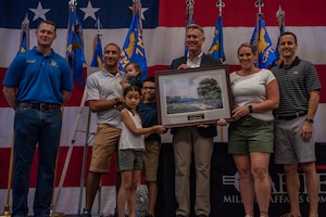 The Gibson family receives the 2022 Abilene Military Family of the Year award during the World’s Largest Barbeque at Abilene, Texas, July 16, 2022. The Abilene Military Family of the Year award recognizes a military family that contributed to both the military and local communities through volunteering. (U.S. Air Force photo by Airman 1st Class Ryan Hayman)