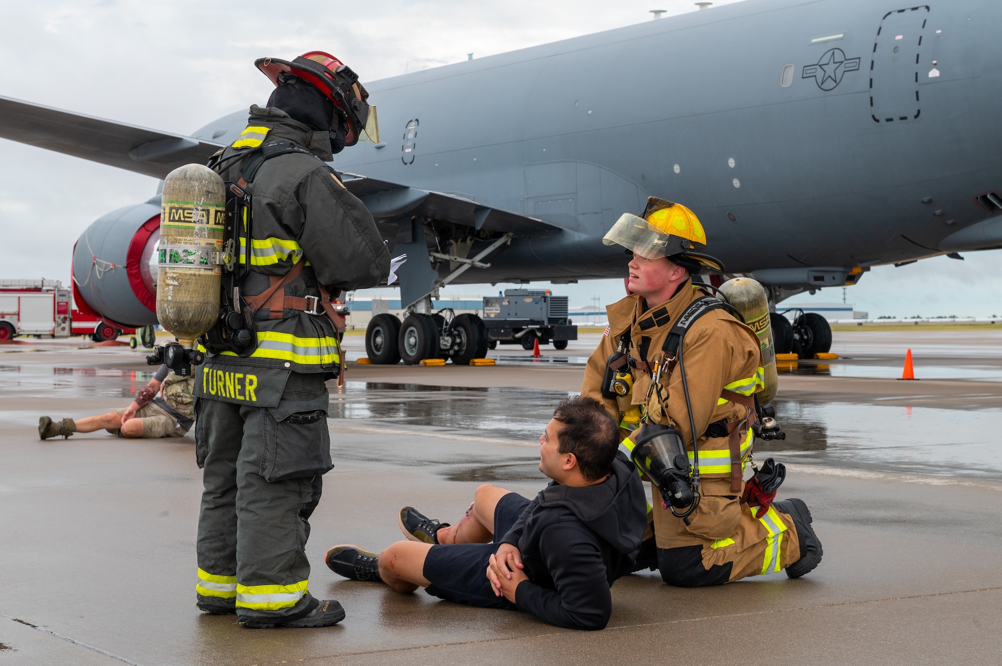 Captain Collin Turner, 22nd Civil Engineering Squadron crew chief, and Airman 1st Class Dylan Tomm, 22 CES firefighter, assess the injuries of a simulated casualty during a Major Accident Response Exercise July 29, 2022, at McConnell Air Force Base, Kansas.