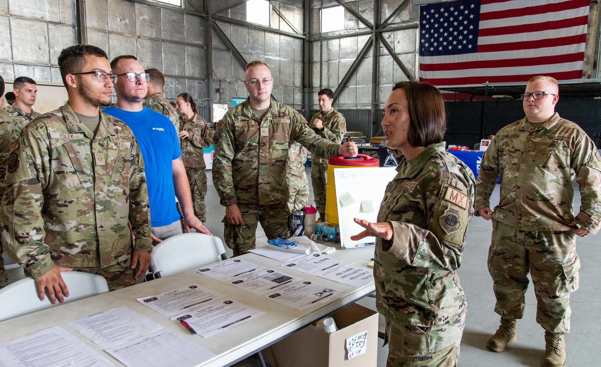 Lt. Col. Josephine Beacham, second from right, 436th Aircraft Maintenance Squadron commander, speaks with Senior Airman Joshua Foley, left, 436th AMXS C-5M Super Galaxy electrical and environmental specialist and Integrated Resiliency Team member, along with other IRT members at The Whole Airman Festival on Dover Air Force Base, Delaware, Aug. 1, 2022. The festival, which was organized and hosted by the 436th AMXS IRT, provided Airmen with on-base resources pertaining to education, health and wellness services. (U.S. Air Force photo by Roland Balik)