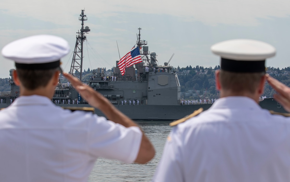 Sailors salute as the Ticonderoga-class guided-missile cruiser USS Lake Champlain (CG 57) participates in the parade of ships during Fleet Week Seattle, Aug. 1, 2022.