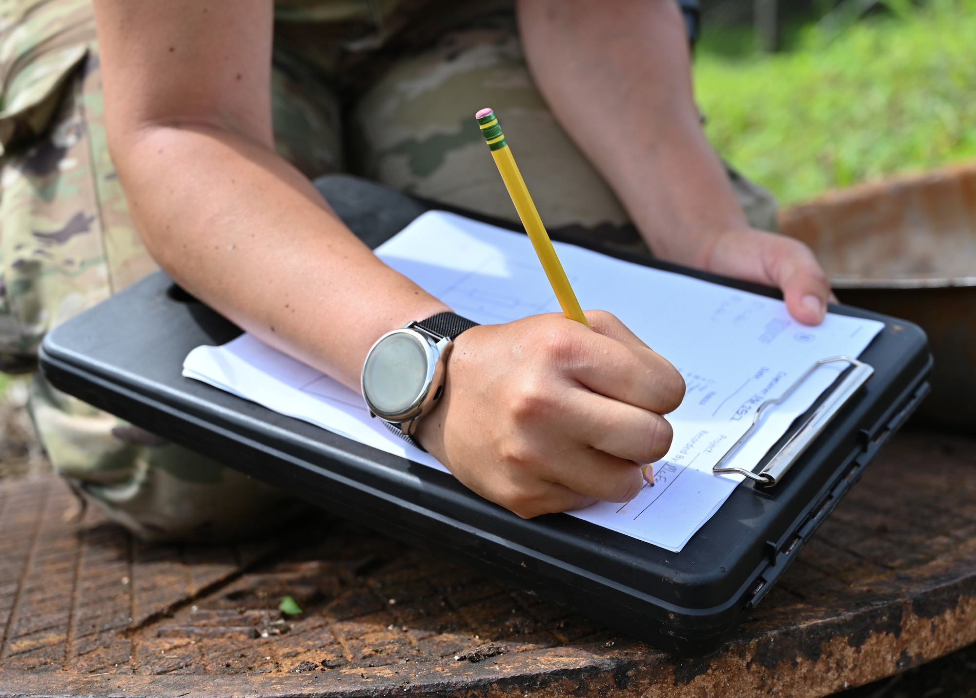 U.S. Air National Guard Staff Sgt. Hollie McFarland, 205th Engineering Installation Squadron safety representative, fills out a butterfly drawing on Andersen Air Force Base, Guam, July 29, 2022. Butterfly drawings are used to document the location of the cable paths in a telecommunications maintenance hole. (U.S. Air Force photo by Airman 1st Class Lauren Clevenger)