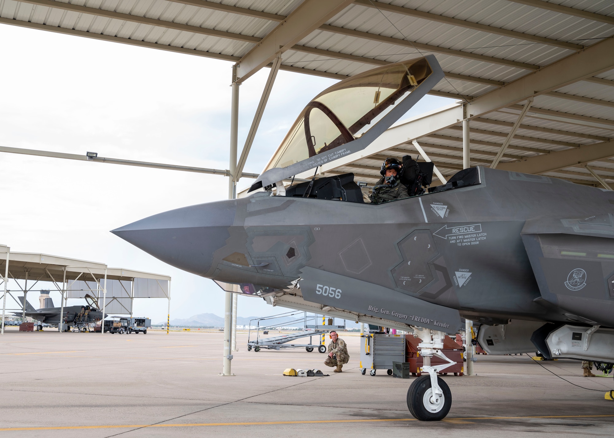 U.S. Air Force Brig. Gen. Gregory Kreuder, 56th Fighter Wing commander, prepares to fly the F-35A Lightning II aircraft for his “fini” flight as Senior Airman Aaron Robosky, 61st Aircraft Maintenance Unit dedicated crew chief, and his team double check the aircraft’s systems July 25, 2022, at Luke Air Force Base, Arizona.