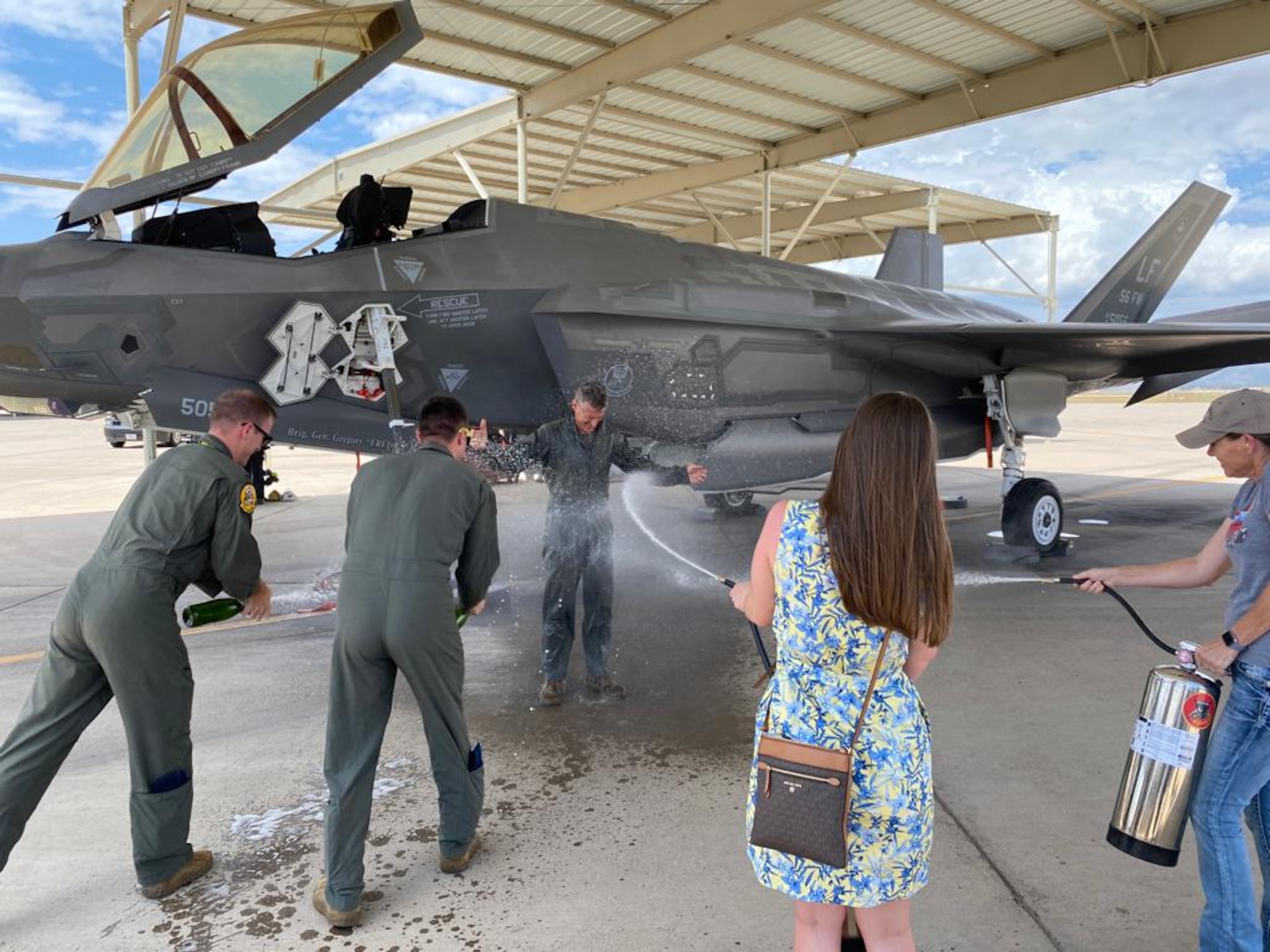 U.S. Air Force Brig. Gen. Gregory Kreuder, 56th Fighter Wing commander, is showered in champagne at the end of his “fini” flight July 25, 2022, at Luke Air Force Base, Arizona.