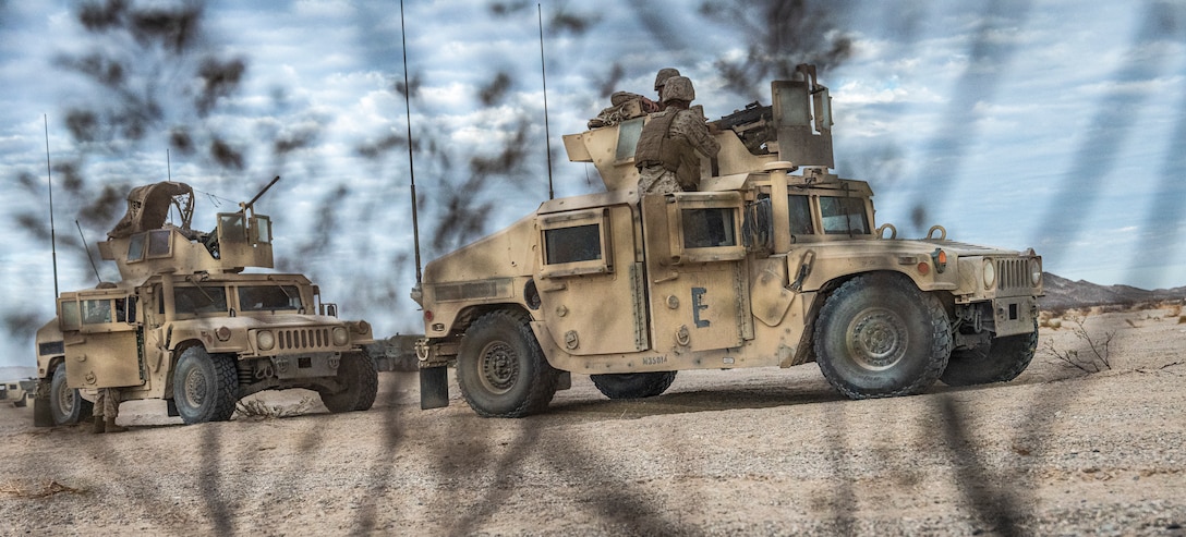 Humvees stage prior to the execution of the mobile operations course on Range 205 during Integrated Training Exercise 4-22 at Marine Corps Air-Ground Combat Center, Twentynine Palms, Calif., July 29, 2022. The mobile operations course challenges supporting elements of the Marine Air-Ground Task Force to respond to contact while delivering logistical supplies to other elements of the MAGTF. ITX is designed to provide large forces the opportunity to command and control their Marines through a live-fire program incorporating every element of the MAGTF. (U.S. Marine Corps photo by Sgt. Matthew Teutsch)