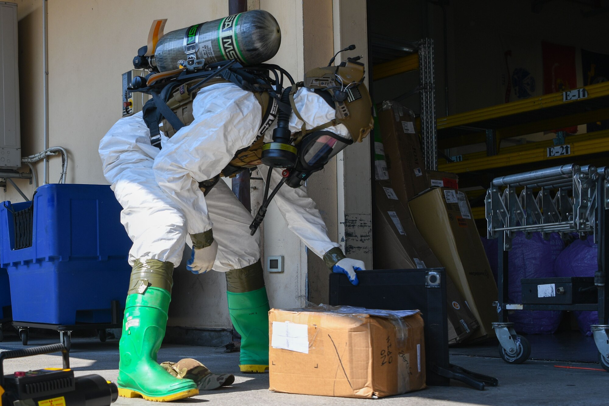 U.S. Air Force Staff Sgt. Julian Venegas, 31st Civil Engineer Squadron explosive ordnance disposal team member, investigates a simulated suspicious package at the post office during an exercise at Aviano Air Base, Italy, July 21, 2022. Exercises provide opportunities to execute training and practice in order to maintain the safety of Aviano AB and its members. (U.S. Air Force photo by Airman 1st Class Thomas Calopedis)