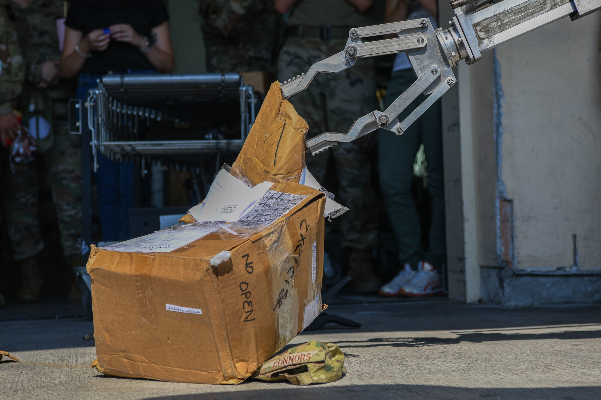 The 31st Civil Engineer Squadron explosive ordnance disposal robot opens a simulated suspicious package during an exercise at Aviano Air Base, Italy, July 21, 2022. After using an x-ray device to see inside of the package, the 31st EOD team opens it from a safe distance. Exercises provide opportunities to execute training and practice in order to maintain the safety of Aviano AB and its members. (U.S. Air Force photo by Airman 1st Class Thomas Calopedis)