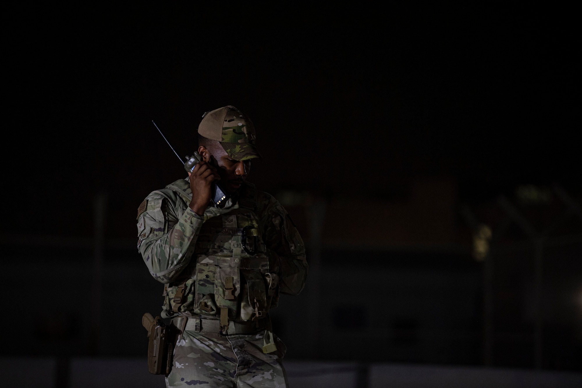 U.S. Air Force Senior Airman Samuel Smith, 379th Expeditionary Security Forces Squadron, communicates with other patrols July 25, 2022 at Al Udeid Air Base, Qatar. Security Forces Defenders keep in constant communication while securing the base and guarding key assets and infrastructure. (U.S. Air National Guard photo by Master Sgt. Michael J. Kelly)