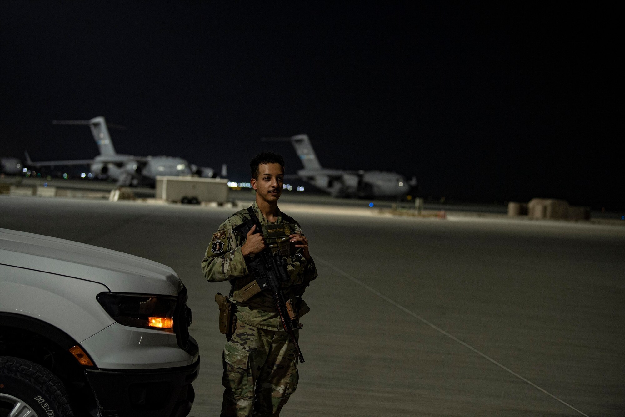U.S. Air Force Senior Airman David Molina, 379th Expeditionary Security Forces Squadron, stands watch on the flight line July 25, 2022 at Al Udeid Airbase, Qatar. Security Forces maintains security over key assets and infrastructure. (U.S. Air National Guard photo by Master. Sgt. Michael J. Kelly)