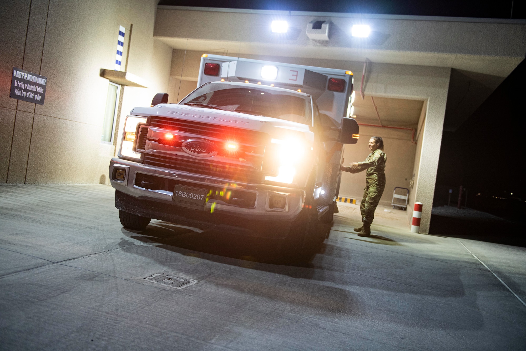 An ambulance flashes it lights during a vehicle checkout inspection July 25, 2022 at Al Udeid Air Base. 379th Expeditionary Medical Group medics maintain constant inspection of vehicles and equipment to ensure they are ready to respond to emergencies.  (U.S. Air National Guard photo by Master. Sgt. Michael J. Kelly)