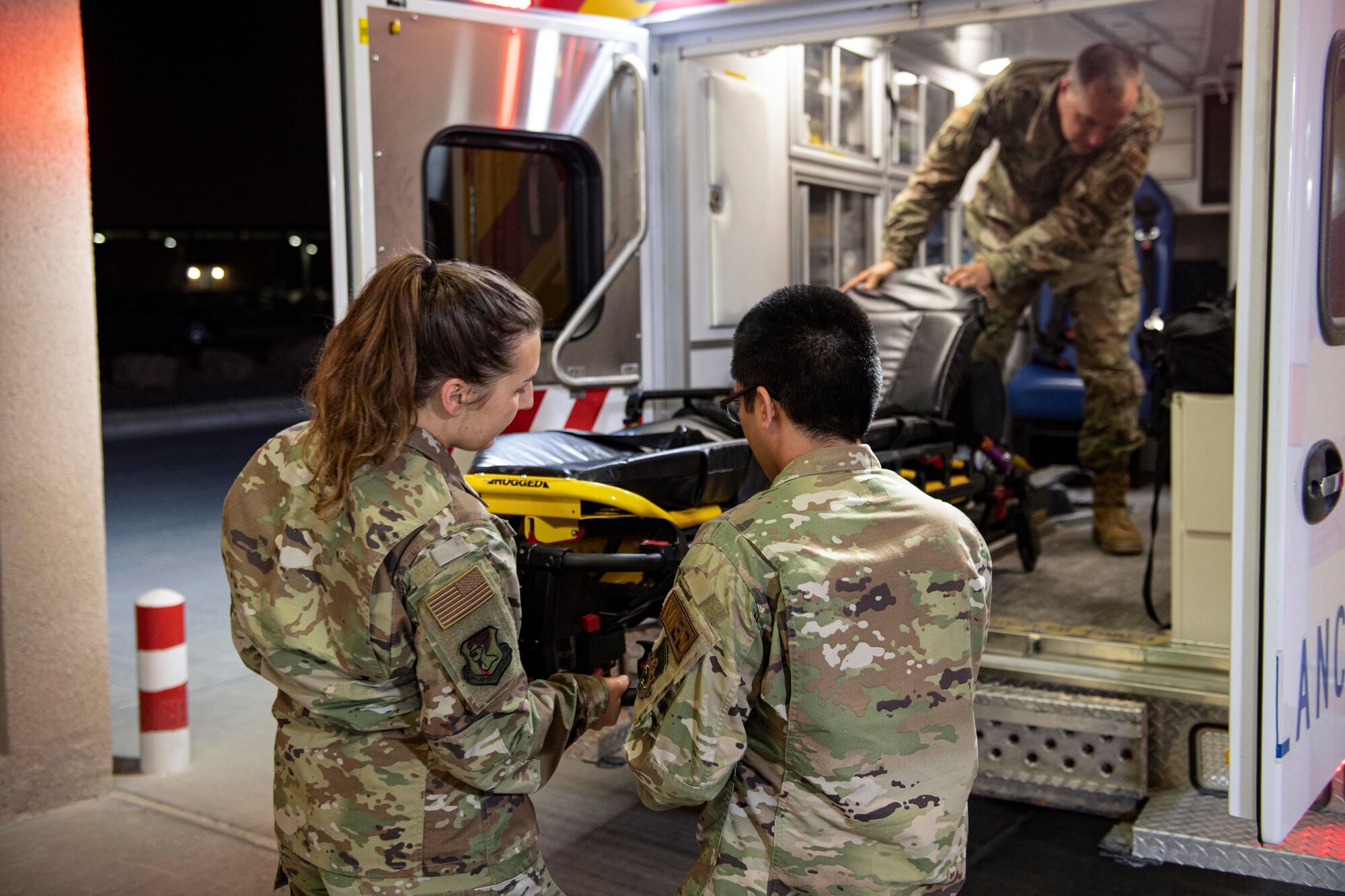 Medics with the 379th Expeditionary Medical Group inspect a stretcher during an ambulance inspection July 25, 2022 at Al Udeid Airbase, Qatar. Medics constantly inspect vehicles and equipment to ensure they are ready to respond to emergencies. (U.S. Air National Guard photo by Master. Sgt. Michael J. Kelly)
