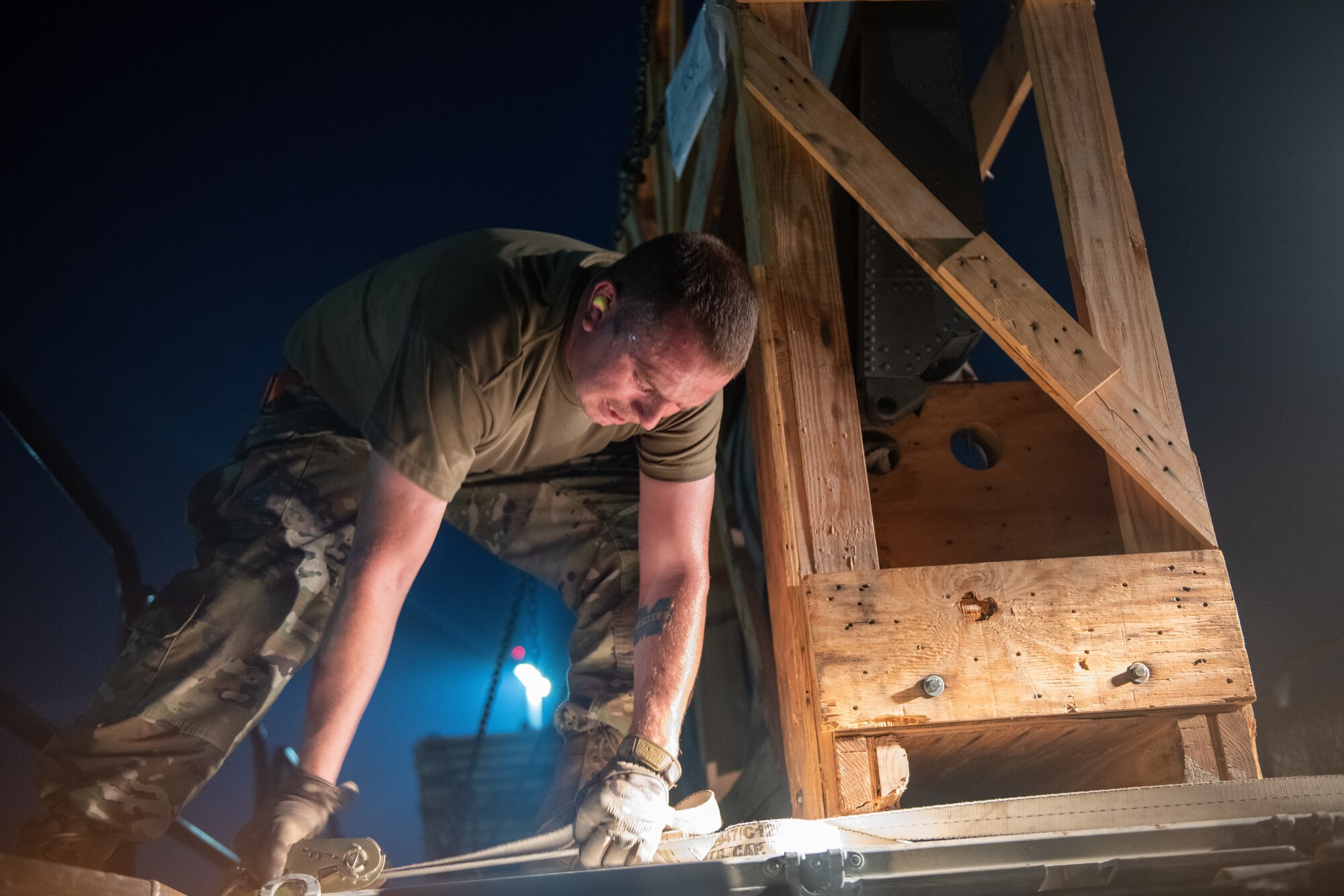 U.S. Air Force Senior Airman Christian Lento, a cargo processing specialist with the 8th Expeditionary Air Mobility Squadron, uses a forklift to load a cargo pallet onto a transport vehicle on Al Udeid Air Base, Qatar, July 23, 2022. Many cargo pallets can be transported on a single transportation vehicle. (U.S. Air National Guard photo by Airman 1st Class Constantine Bambakidis)