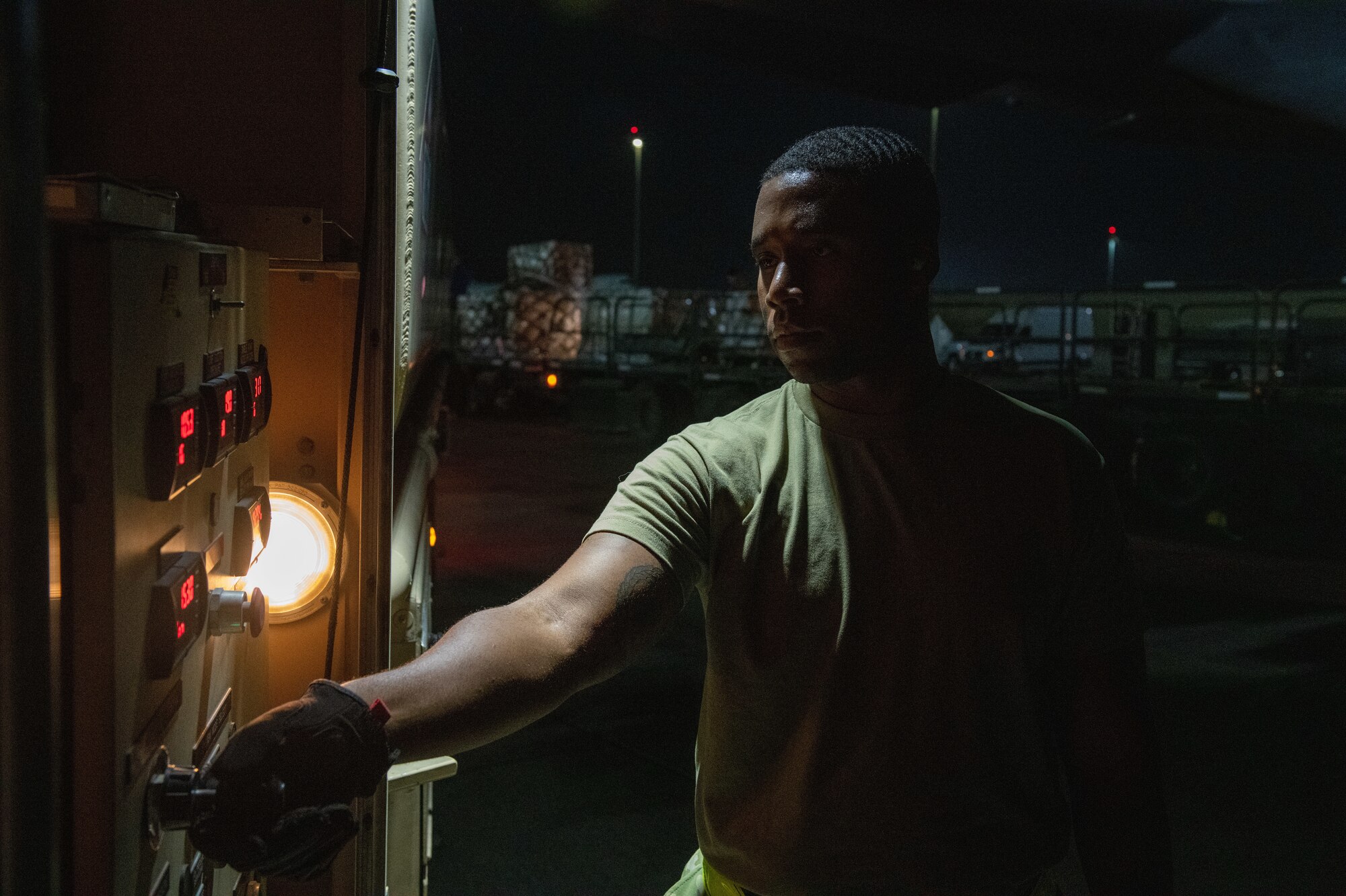 U.S. Air Force Senior Airman Derik Pete, a distribution operator from the 379th Expeditionary Logistics Readiness Squadron, configures fuel controls while refueling a C-130 on Al Udeid Air Base, Qatar, July 18, 2022. The fueling process can be completed in around 10 minutes. (U.S. Air National Guard photo by Airman 1st Class Constantine Bambakidis)