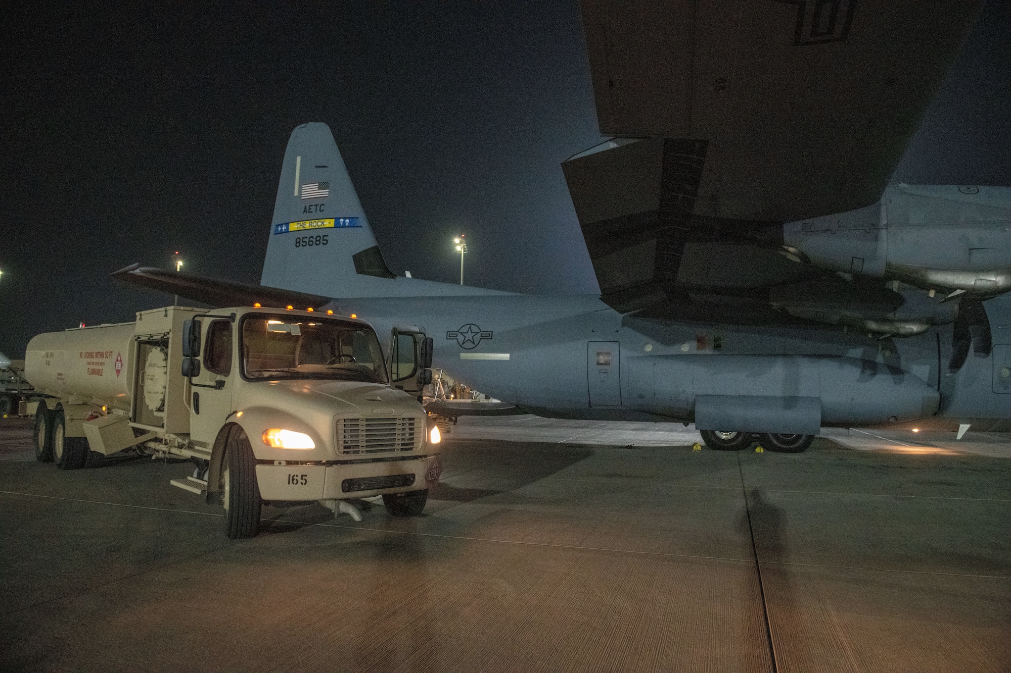 A fuel truck belonging to the U.S. Air Force 379th Expeditionary Logistics Readiness Squadron sits next to a C-130 prior to refueling on Al Udeid Air Base, Qatar, July 18, 2022. Different aircraft require different types of fuel.  (U.S. Air National Guard photo by Airman 1st Class Constantine Bambakidis)