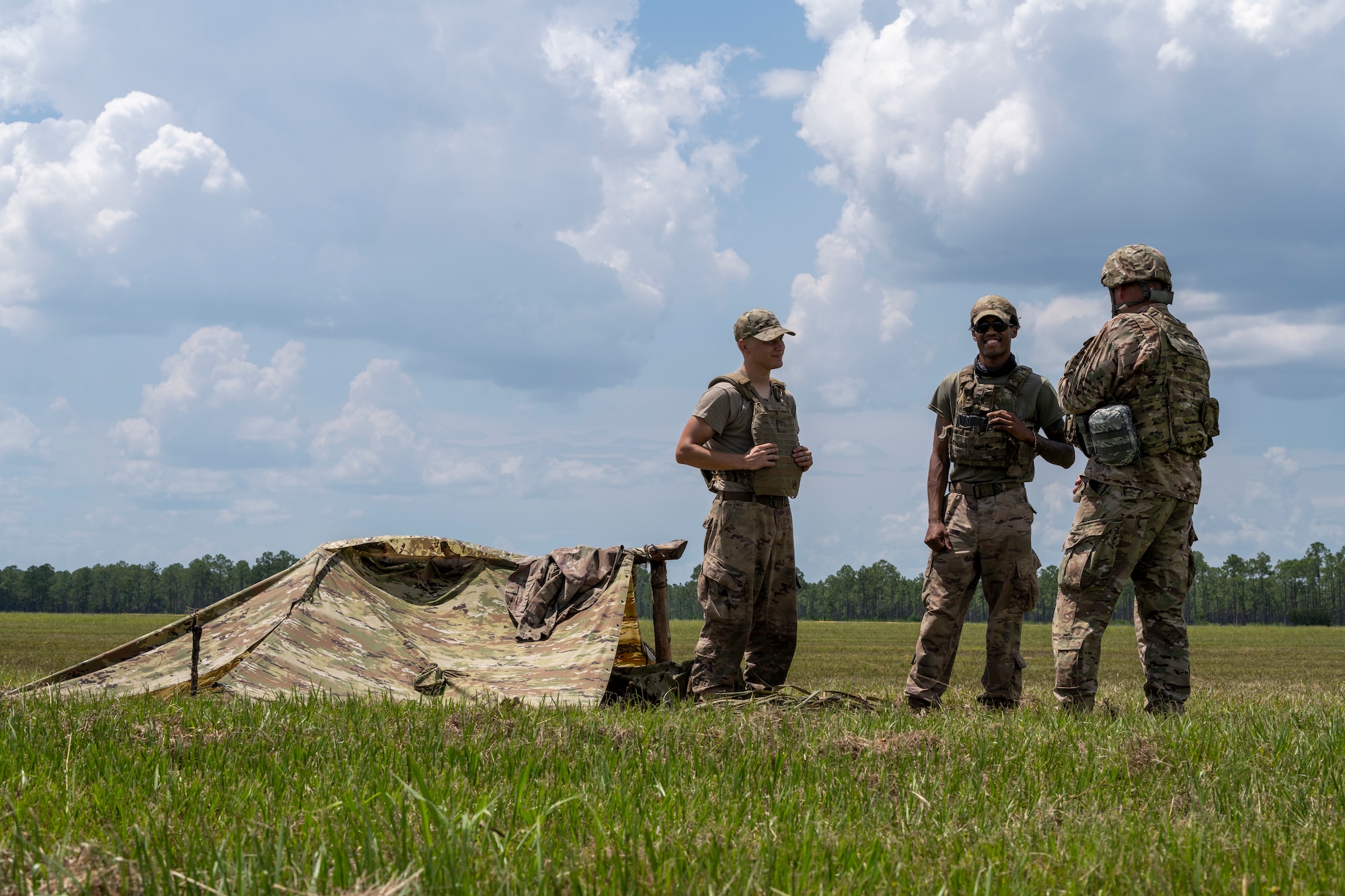 The 23rd Wing command chief talks with Airmen in a field during exercise Agile Flag.