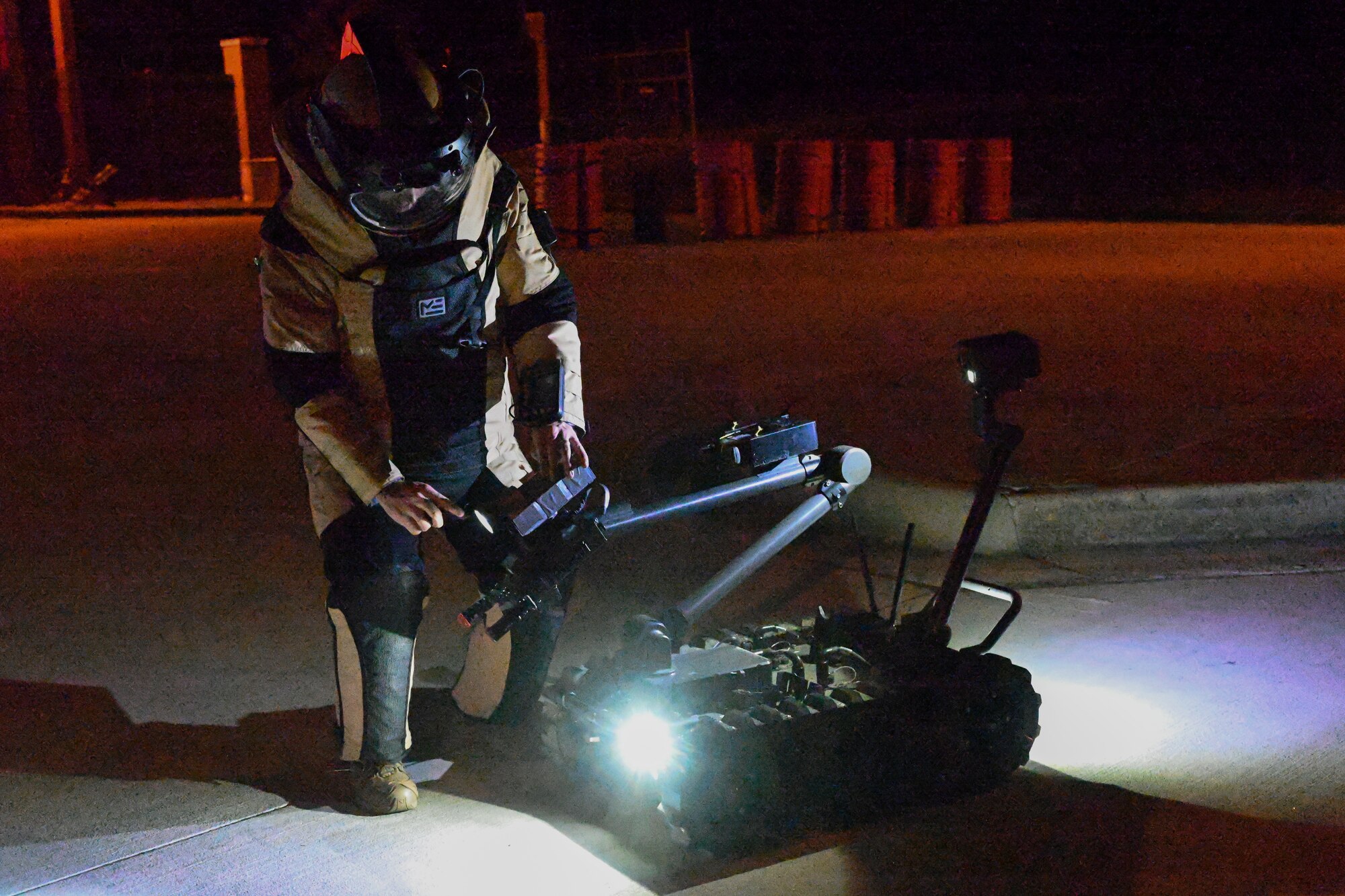 An Airman prepares a robot.