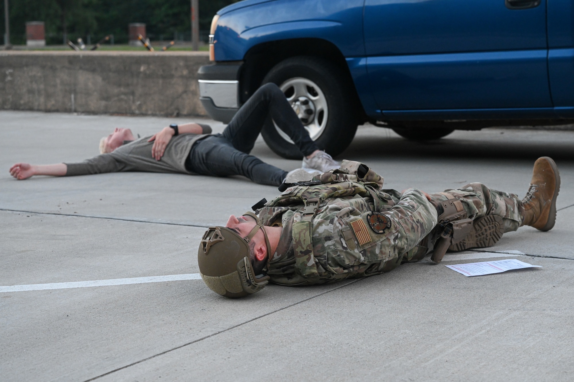 An airman lies on the ground.