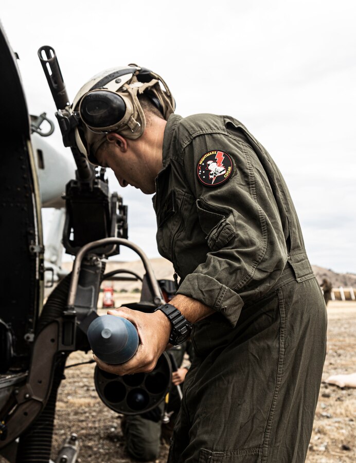 A U.S. Marine with Marine Wing Support Squadron 372, Marine Aircraft Group 39, 3rd Marine Aircraft Wing, loads ordnance onto a UH-1Y Venom during Summer Fury 22 at Camp Roberts, San Miguel, California, August 1, 2022. Summer Fury 22 enhances Marine-Air-Ground Task Force integration and increases aviation operations proficiency with realistic, relevant training to ensure the Marine Corps’ largest aircraft wing remains operationally excellent, interoperable, deployable on short notice and lethal when called into action. (U.S. Marine Corps Photo by Cpl. Woodward)