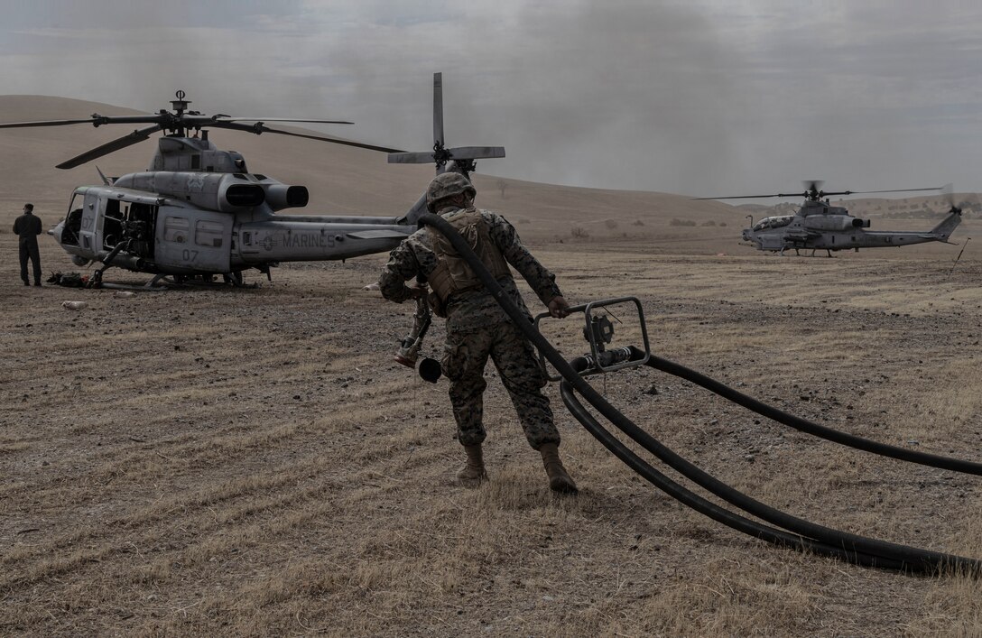 U.S. Marine Corps Lance Cpl. a bulk fuel specialist with Marine Wing Support Squadron 372, Marine Aircraft Group 39, 3rd Marine Aircraft Wing, refuels a UH-1Y Venom at a forward arming and refueling point during exercise Summer Fury 22 at Camp Roberts, San Miguel, California, August 1, 2022. Summer Fury 22 enhances Marine-Air-Ground Task Force integration and increases aviation operations proficiency with realistic, relevant training to ensure the Marine Corps’ largest aircraft wing remains operationally excellent, interoperable, deployable on short notice and lethal when called into action. (U.S. Marine Corps Photo by Cpl. Woodward)