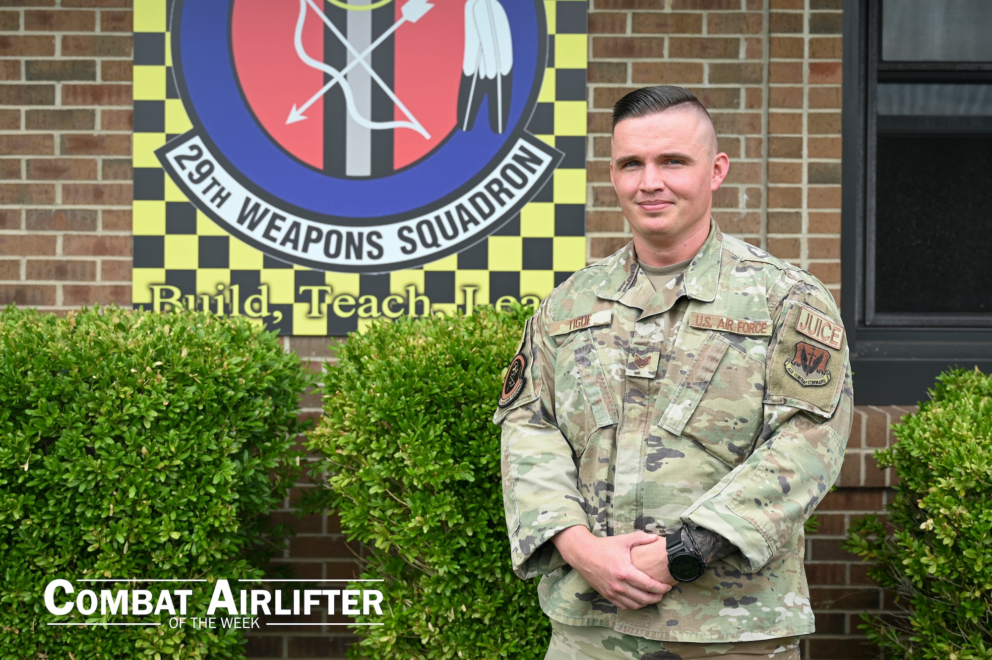 A man in uniform poses for a photo outside.