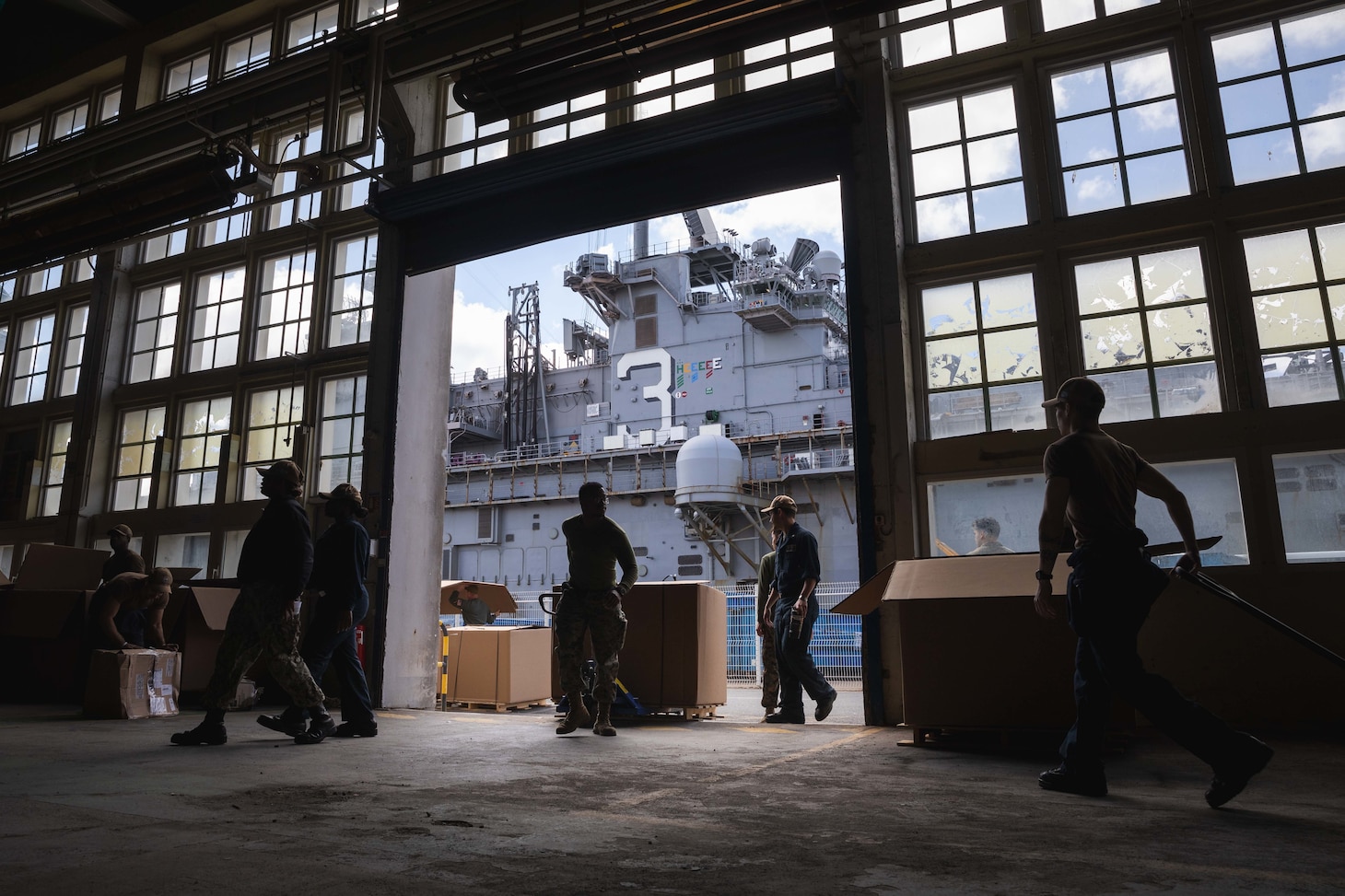 U.S. Marines and Sailors sort mail delivered to the Wasp-class amphibious assault ship USS Kearsarge (LHD 3) while in port in Brest, France, July 5, 2022.