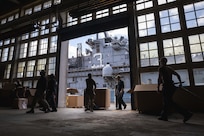 U.S. Marines and Sailors sort mail delivered to the Wasp-class amphibious assault ship USS Kearsarge (LHD 3) while in port in Brest, France, July 5, 2022.