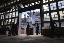 U.S. Marines and Sailors sort mail delivered to the Wasp-class amphibious assault ship USS Kearsarge (LHD 3) while in port in Brest, France, July 5, 2022.
