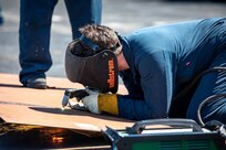 Hull Maintenance Technician 3rd Class Glenn Alexander, from Fort Worth, Texas, assigned to the San Antonio-class amphibious transport dock ship USS Arlington (LPD 24), cuts through carbon steel using a plasma torch during preservation work for mid-deployment voyage repairs in Rijeka, Croatia, July 6, 2022.