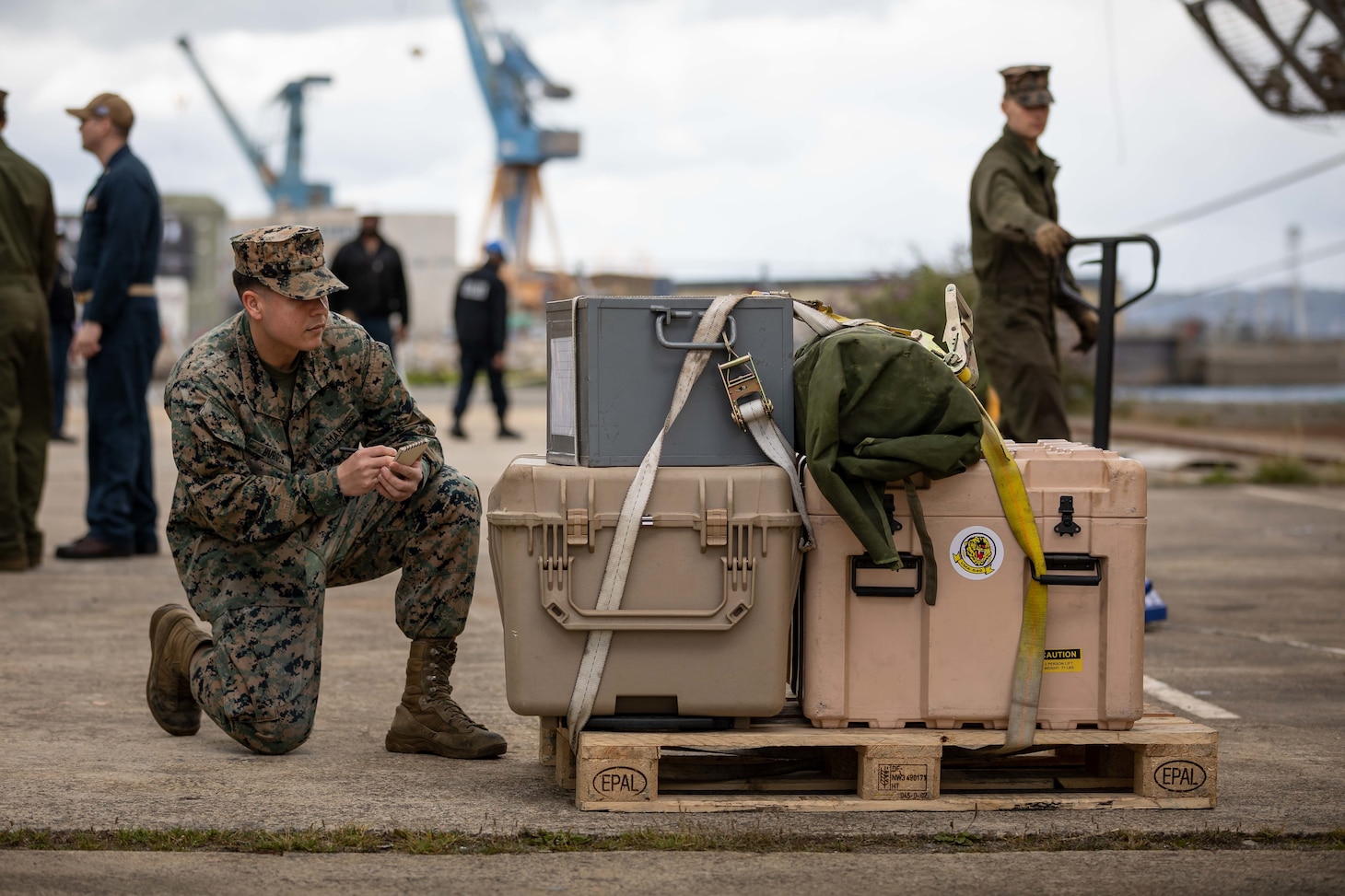 Lance Cpl. Keniel Burgos, an embarkation specialist assigned to the 22nd Marine Expeditionary Unit , takes inventory of supplies delivered to the Wasp-class amphibious assault ship USS Kearsarge (LHD 3), during mid-deployment voyage repairs in Brest, France, June 30, 2022.