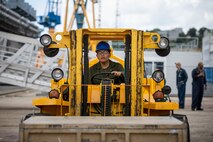 U.S. Marine Corps Lance Cpl. Duane Takala, a network administrator assigned to the 22nd Marine Expeditionary Unit, uses a forklift to maneuver a supply crate designated for the Wasp-class amphibious assault ship USS Kearsarge (LHD 3), during mid-deployment voyage repairs in Brest, France, June 30, 2022.