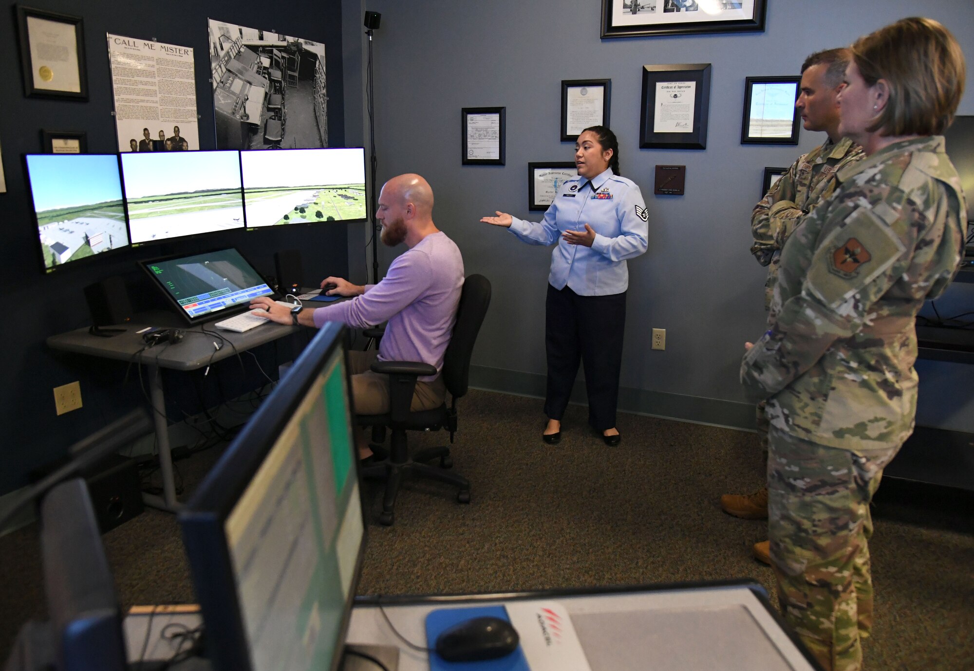 U.S. Air Force Staff Sgt. Susana Twilley, 334th Training Squadron instructor, provides an air traffic control training simulator briefing to Col. Nicholas Dipoma, Second Air Force vice commander, and Chief Master Sgt. Kathleen McCool, Second Air Force command chief, during an immersion tour of the 81st Training Group inside Cody Hall at Keesler Air Force Base, Mississippi, July 29, 2022. The tour also included the Levitow Training Support Facility and the 81st Medical Group clinical research lab. (U.S. Air Force photo by Kemberly Groue)