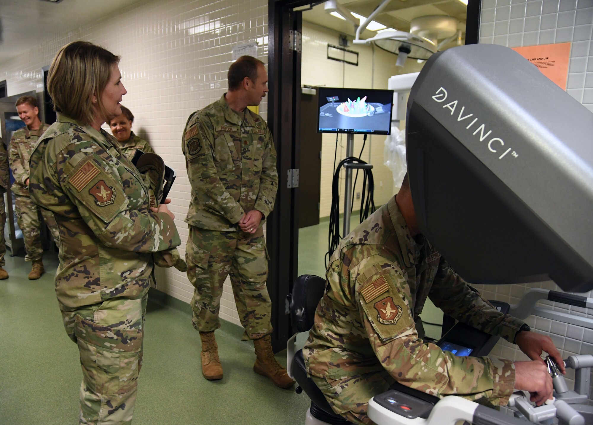 U.S. Air Force Col. Nicholas Dipoma, Second Air Force vice commander, operates a Da Vinci Robot trainer while Chief Master Sgt. Kathleen McCool, Second Air Force command chief, stands by during an immersion tour inside the 81st Medical Group clinical research lab at Keesler Air Force Base, Mississippi, July 29, 2022. The tour also included the 334th Training Squadron air traffic control simulator and the Levitow Training Support Facility. (U.S. Air Force photo by Kemberly Groue)