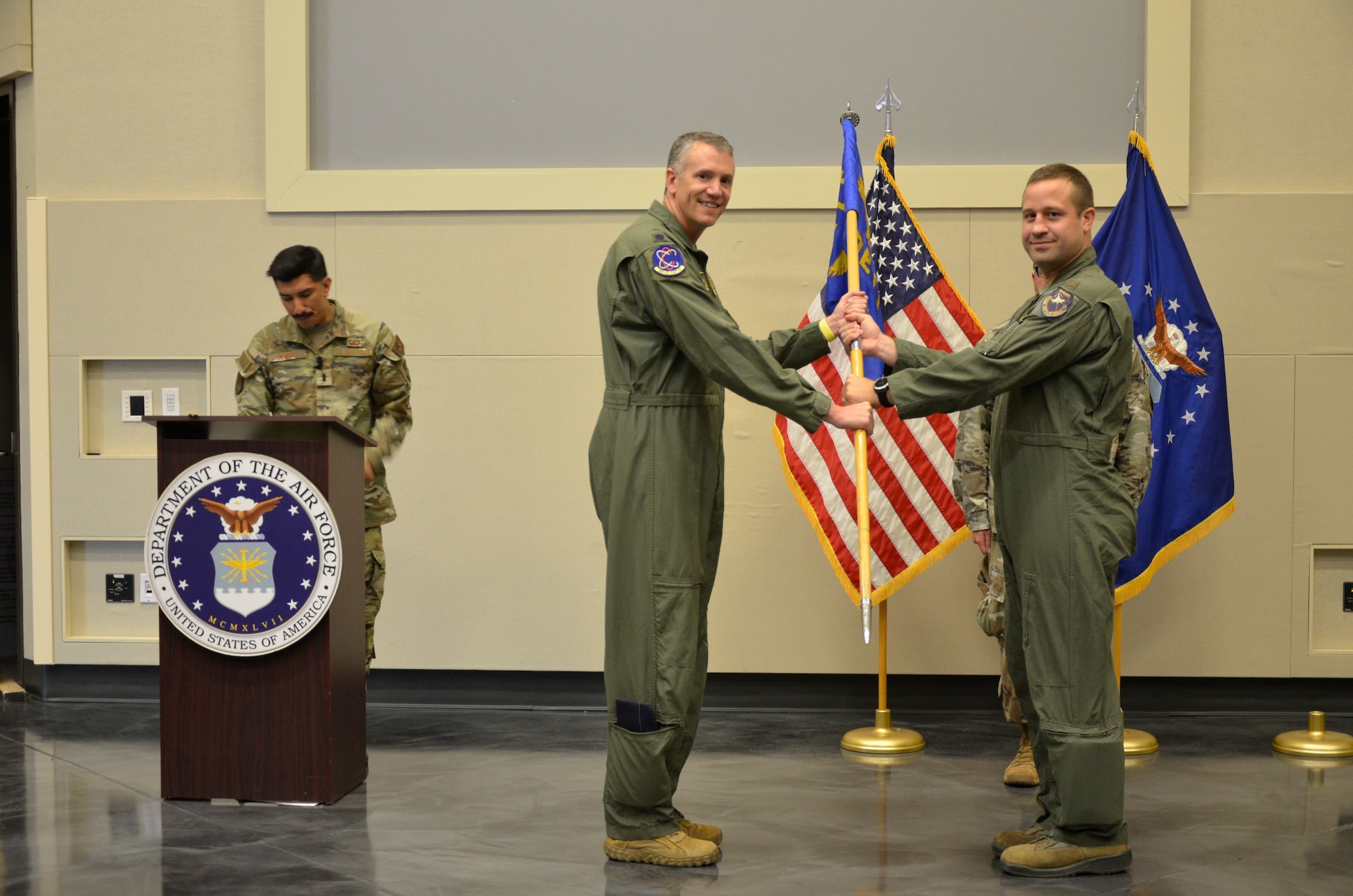 Lt. Col. Alex Wolfard, then-commander of the 586th Flight Test Squadron at Holloman Air Force Base, New Mexico, passes the 586th Flight Test Squadron, Detachment 1, guidon to Maj. Joshua Smith charging him with command of the detachment during a July 13, 2022, change of command ceremony at White Sands Missile Range, New Mexico. (U.S. Army photo by Anne Marie Chadima)