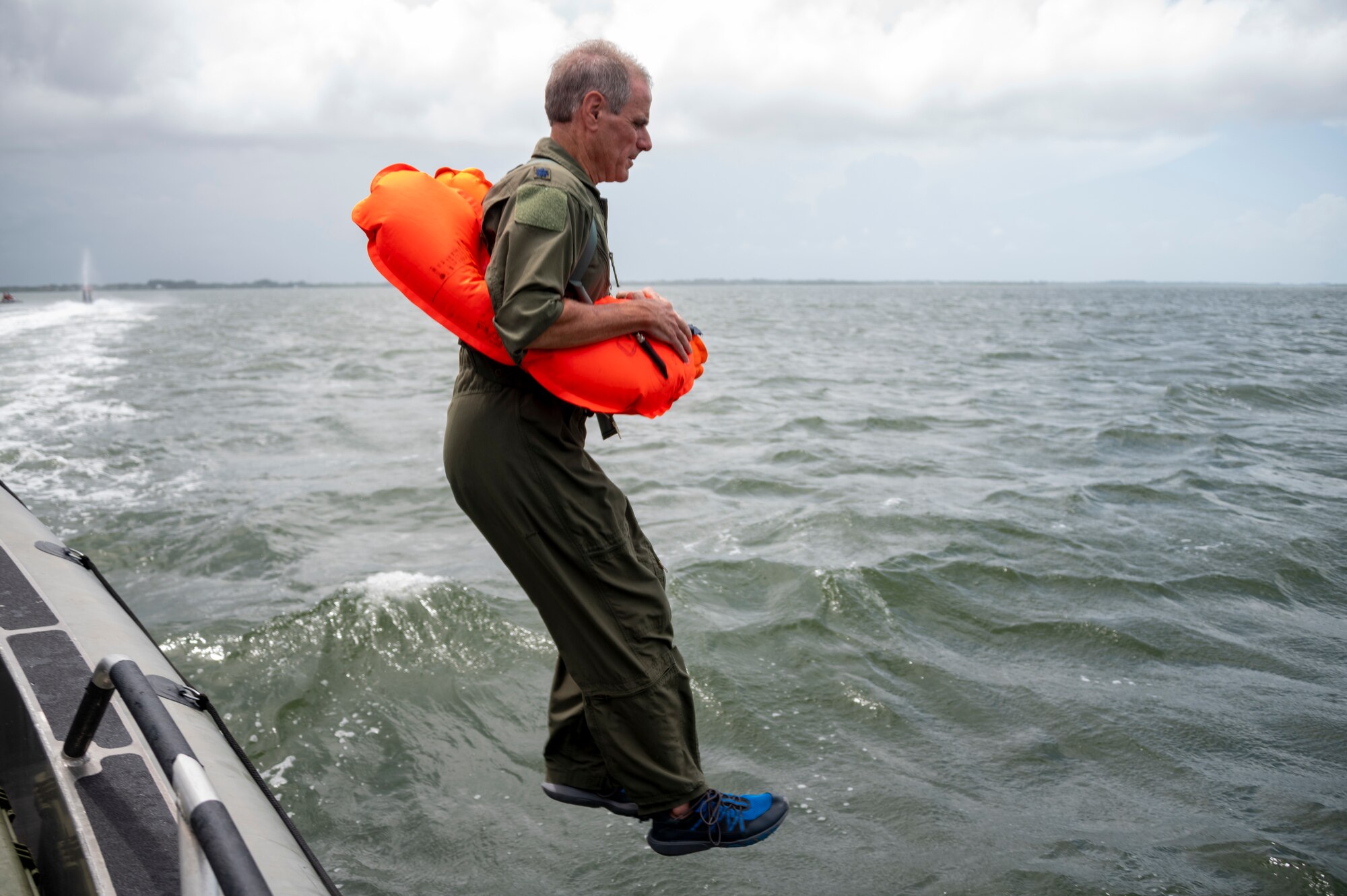 Photo of Airman jumping in the water.